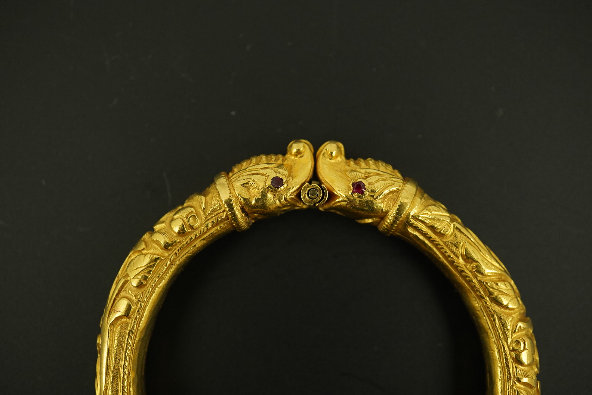 An antique Indian? high carat gold hinged bangle